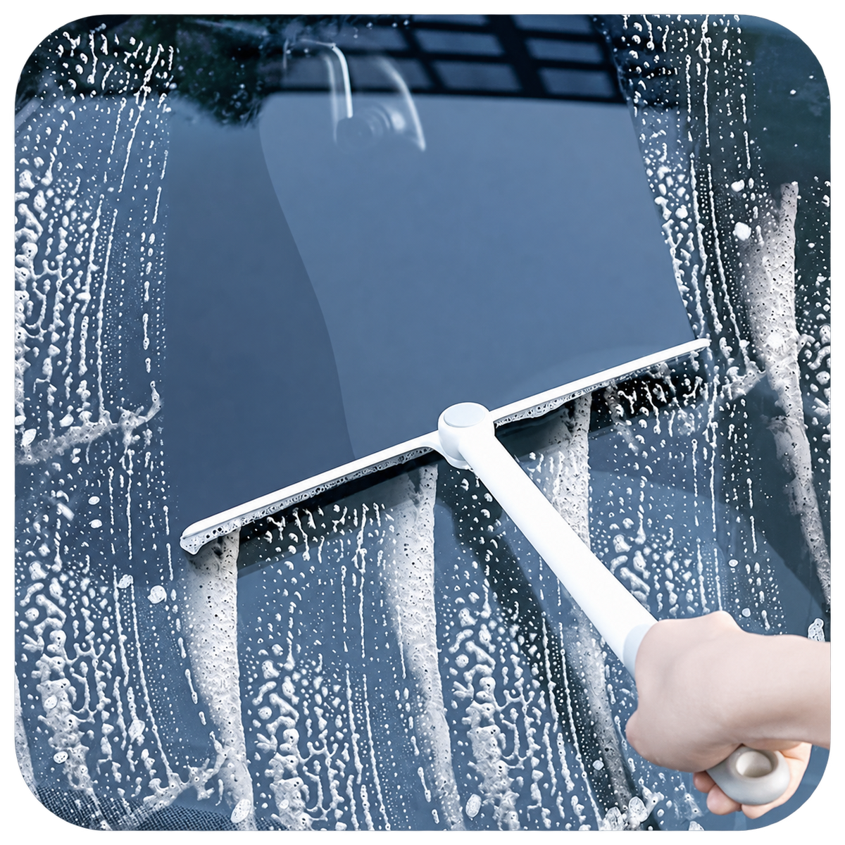 Long-handle squeegee removing water from a car windshield